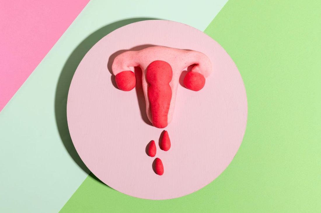 A modeling clay uterus with drops of blood, to illustrate uterine bleeding.